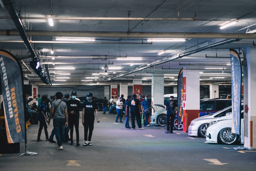 a group of people standing in a parking garage