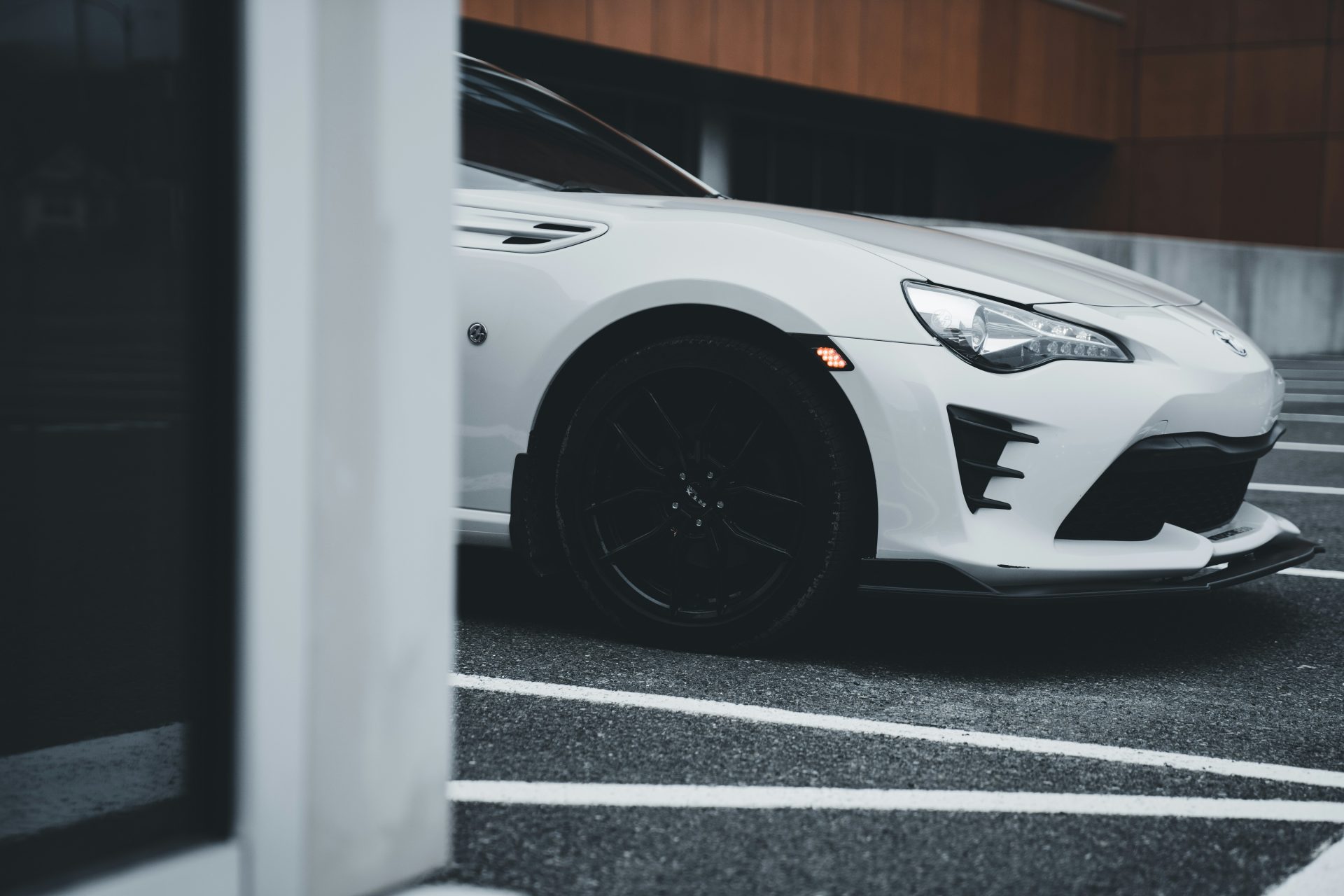 a white sports car parked in a parking lot